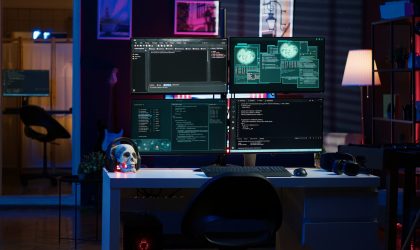 Script running on computer in secret base of operations used by hacker to steal data. Programming language on screen in empty room used by cybercriminal, attacking firewalls